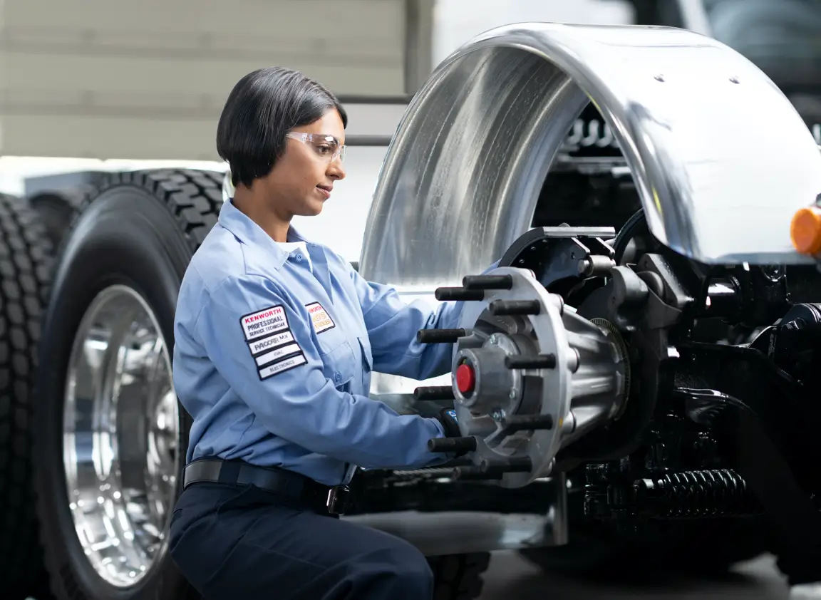 A technician services a Kenworth truck